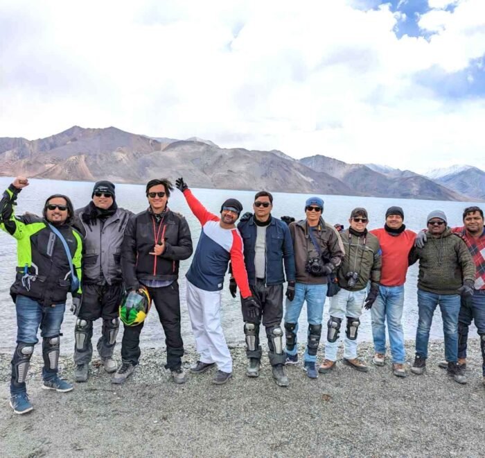 Bike riders enjoying the picturesque Pangong Lake.