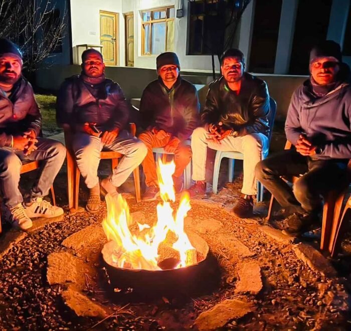 Warm bonfire illuminating the night sky at Nubra Valley.